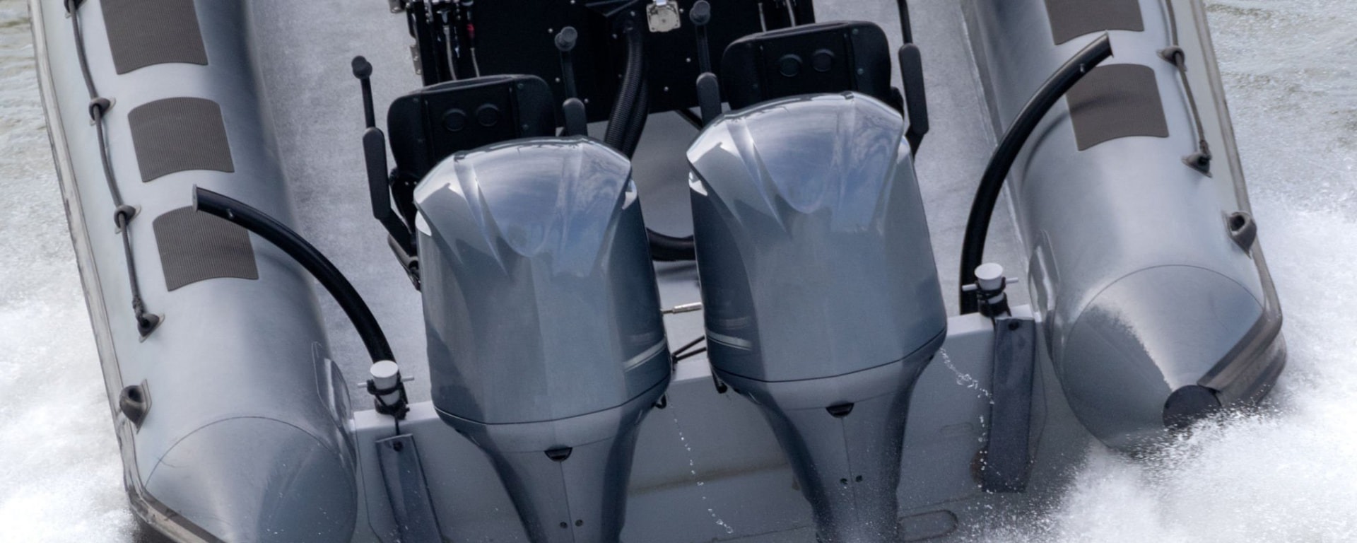 Twin outboard marine propulsion units driving through white water